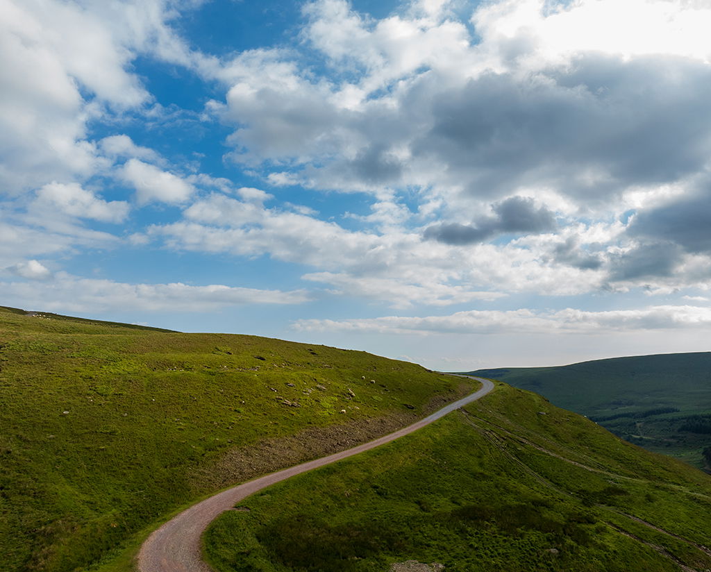 image of a mountain with a road veering off into the horizon