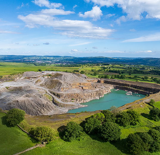 image of a quarry with lush blue water