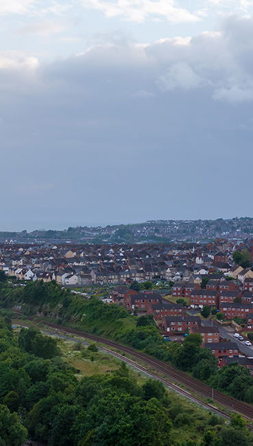 image of a row of streets with a rail line in view